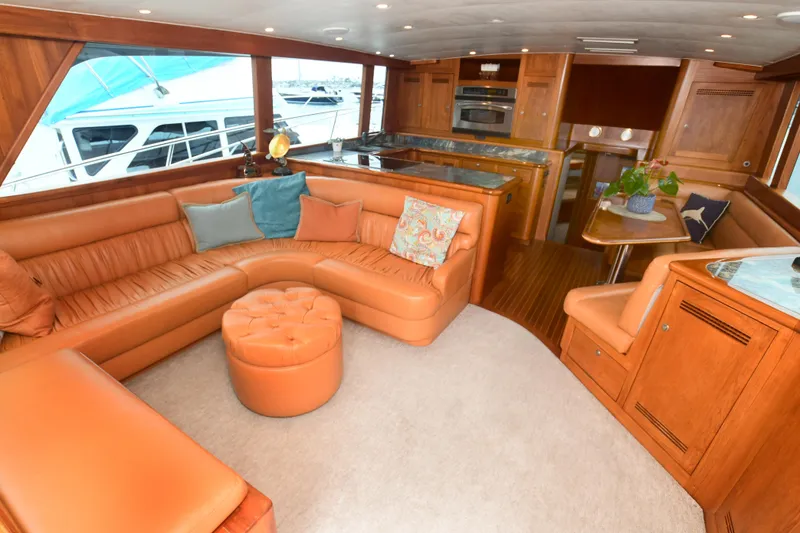 Slide: The Image of Luxurious interior of a 1988 Bertram 54 Convertible yacht with leather seating and wooden finishes. - 35
