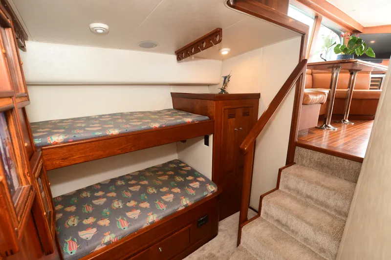 Slide: The Image of 1988 Bertram 54 Convertible interior with bunk beds and stairs to dining area. - 39