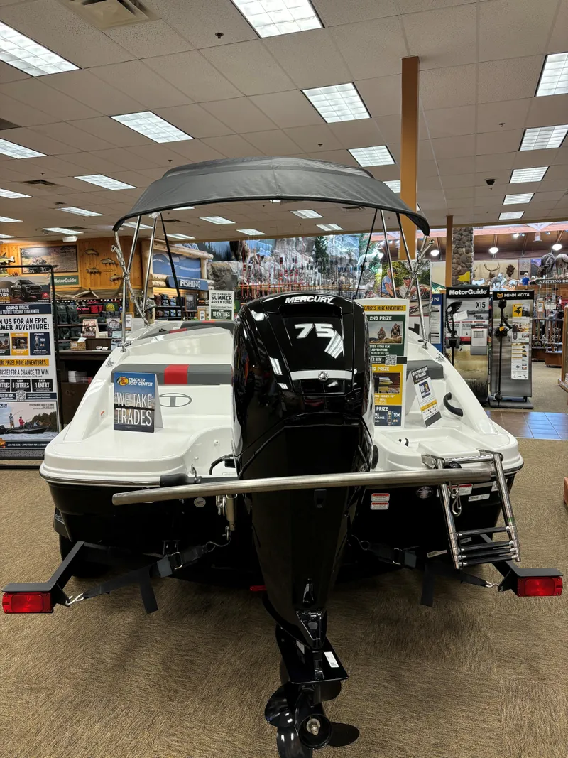 Slide: The Image of 2023 Tahoe T16 boat with Mercury 75 engine displayed indoors. - 3