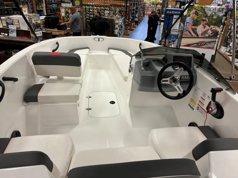 Slide: The Image of 2023 Tahoe T16 boat interior with seating and steering console. - 5