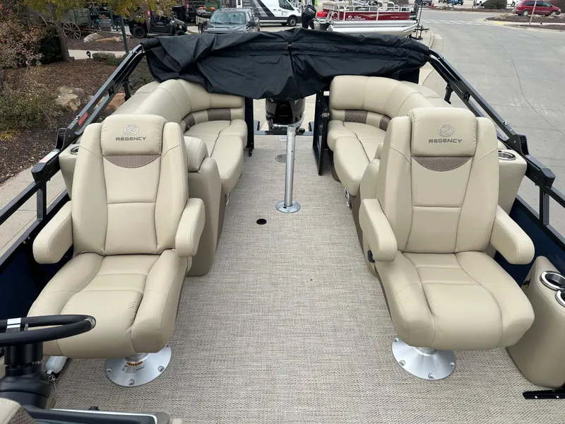Slide: The Image of 2023 Regency 230 LE3 pontoon boat with beige leather seating and spacious deck. - 3