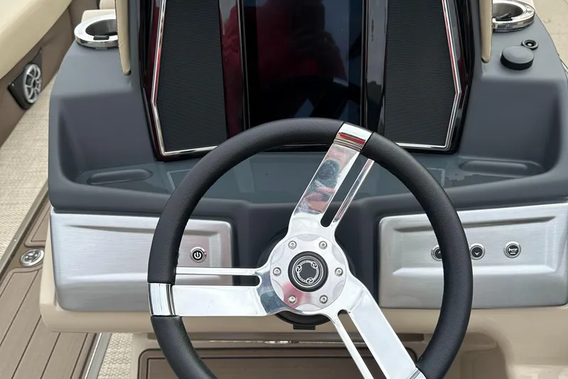 Slide: The Image of 2023 Regency 230 LE3 boat steering wheel and dashboard. - 5