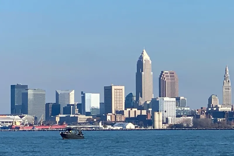 Slide: The Image of Extreme Boats 795 Walk Around 2022 on water with city skyline backdrop. - 23