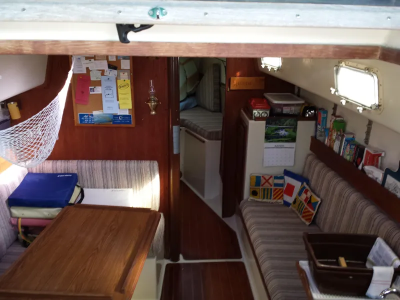 Slide: The Image of Interior of a 1983 Watkins 32 sailboat with cozy seating and nautical decor. - 12