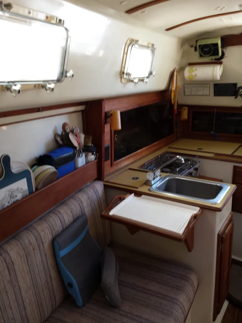 Slide: The Image of Interior of 1983 Watkins 32 sailboat with kitchenette and seating area. - 21