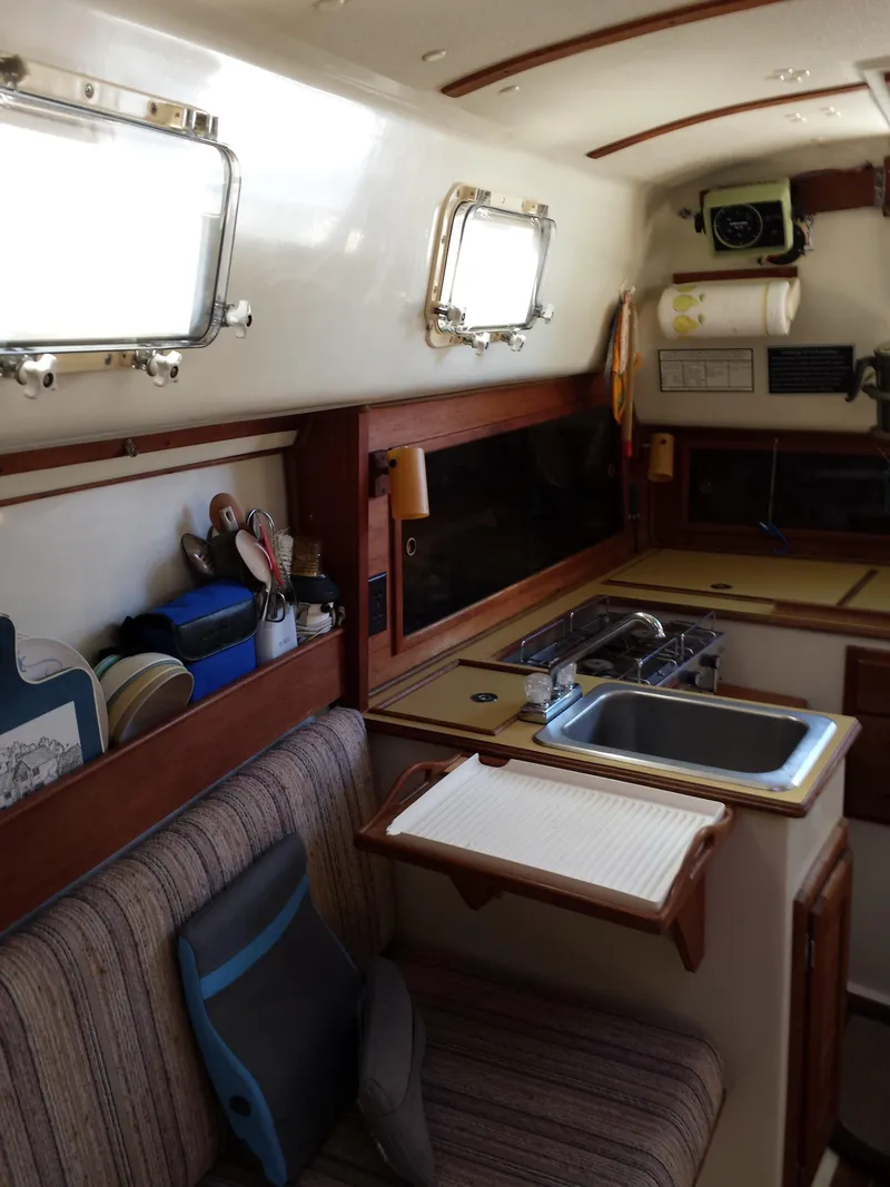 Slide: The Image of Interior of 1983 Watkins 32 sailboat with kitchenette and seating area. - 22