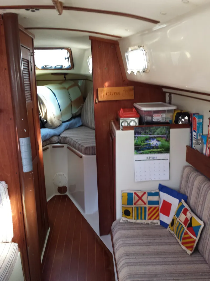 Slide: The Image of Interior of a 1983 Watkins 32 sailboat with cozy cabin and nautical decor. - 23