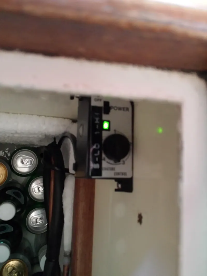 Slide: The Image of Control panel inside a Watkins 32 (1983) boat refrigerator with beverage cans. - 29