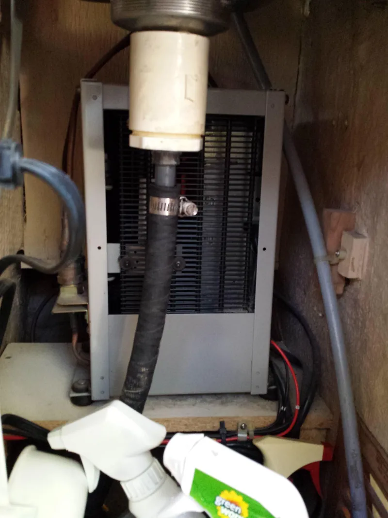 Slide: The Image of 1983 Watkins 32 engine compartment with hoses and wiring. - 34