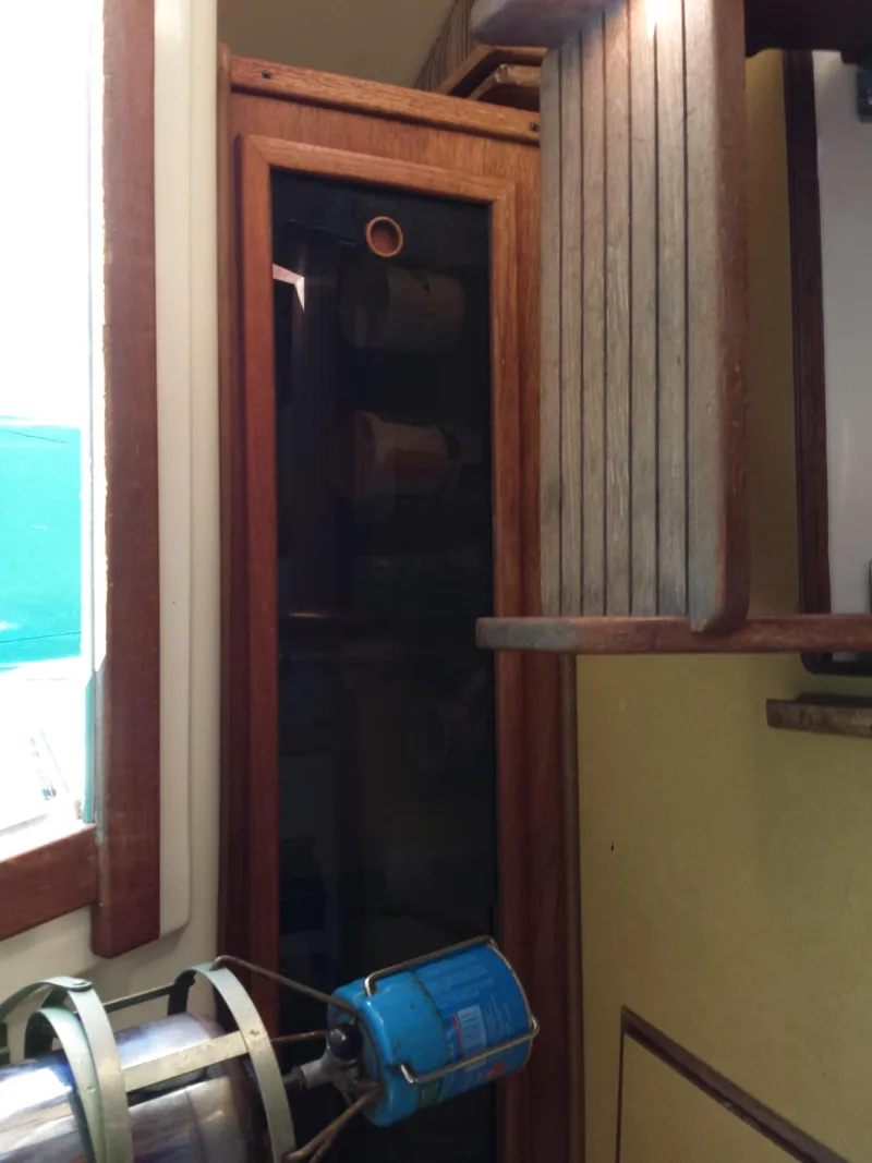 Slide: The Image of 1983 Watkins 32 interior with wooden cabinetry and nautical equipment. - 35