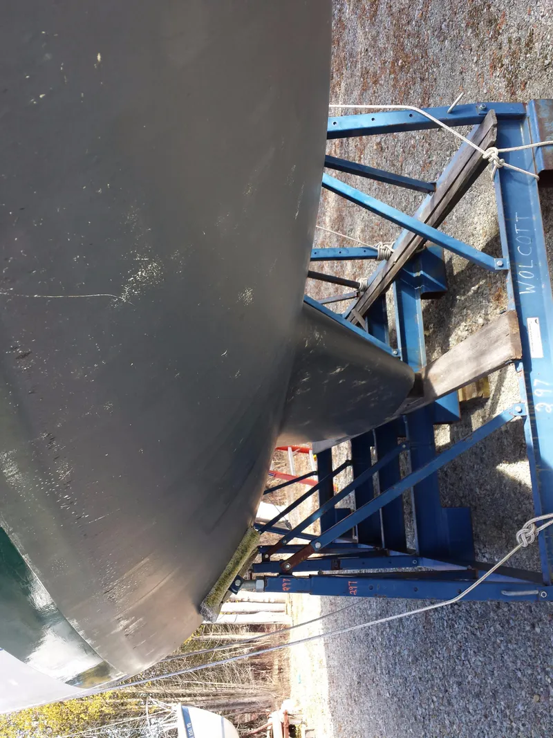 Slide: The Image of 1983 Watkins 32 sailboat hull on a blue metal stand. - 40