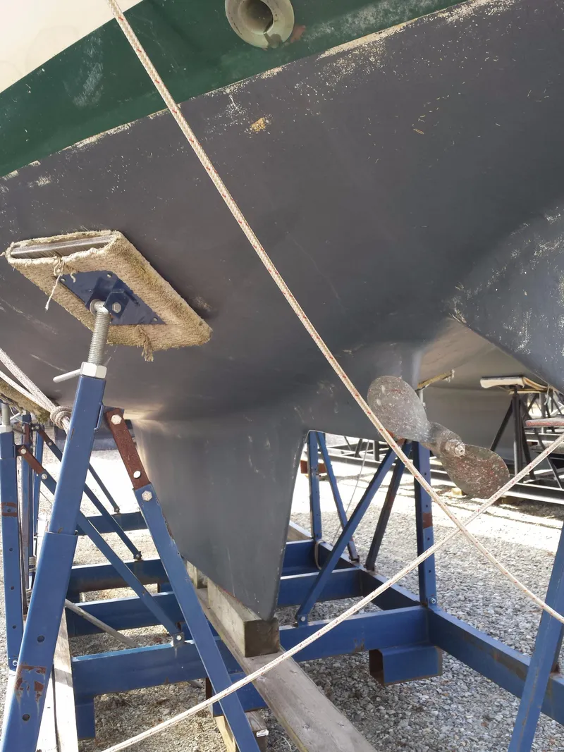 Slide: The Image of 1983 Watkins 32 sailboat hull on stands, showing keel and propeller. - 42