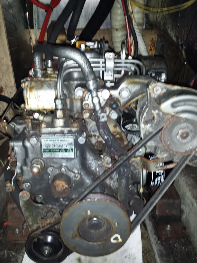 Slide: The Image of Engine of a 1983 Watkins 32 boat, showing belts and components. - 46