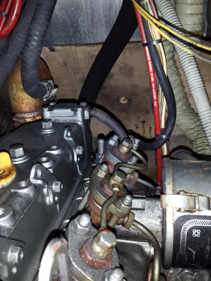 Slide: The Image of Engine components of a 1983 Watkins 32, featuring wires and metal parts. - 47