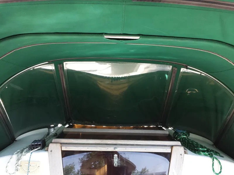 Slide: The Image of 1983 Watkins 32 sailboat cockpit with green canopy and clear windows. - 8