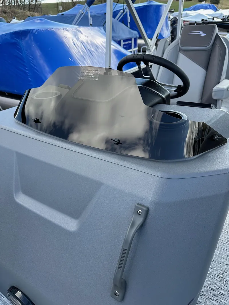 Slide: The Image of 2025 Bennington 22 SF Family Pontoon dashboard with steering wheel and cup holders. - 15