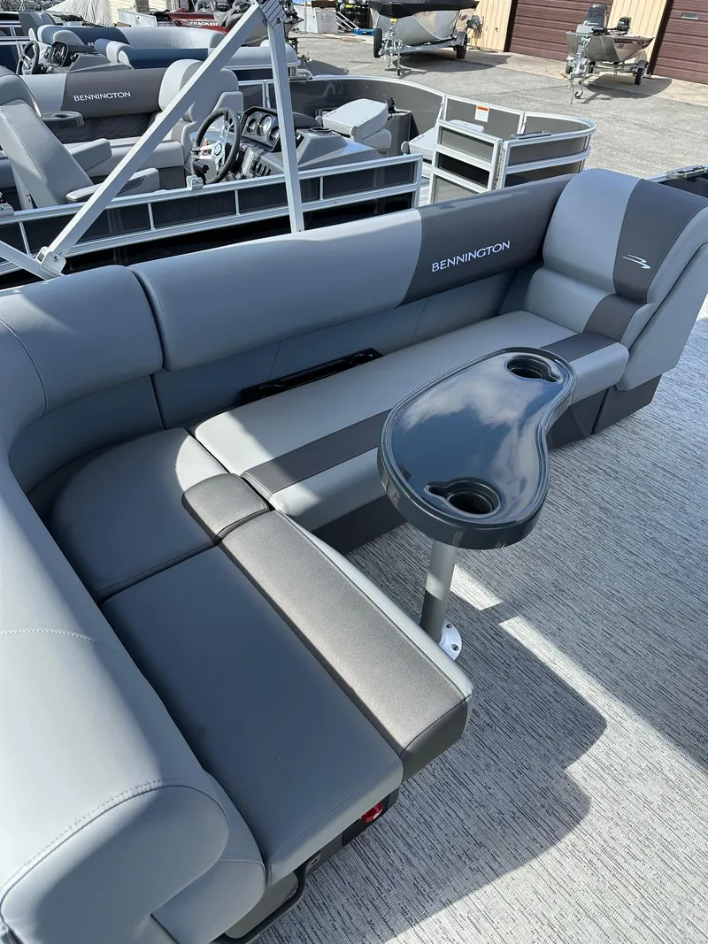 Slide: The Image of 2025 Bennington 22 SF Family Pontoon with gray seating and table, ideal for fishing. - 18
