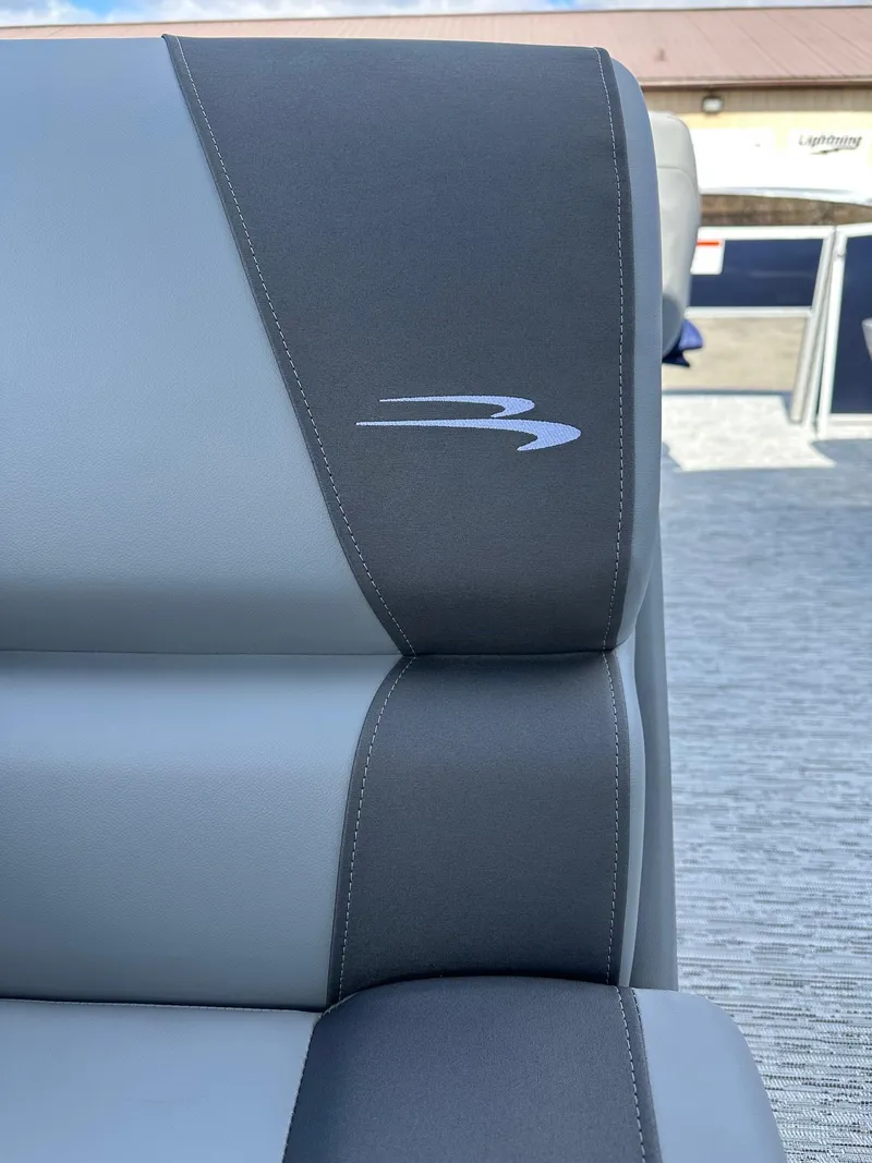 Slide: The Image of 2025 Bennington 22 SF pontoon seat with logo, featuring sleek gray upholstery. - 20