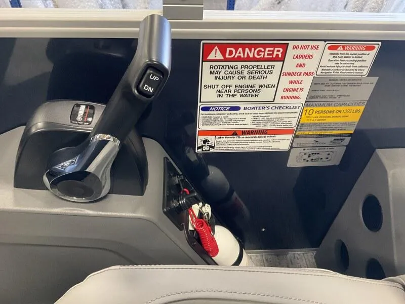 Slide: The Image of Control panel of 2025 Bennington 22 SF Pontoon with safety warnings and throttle lever. - 23