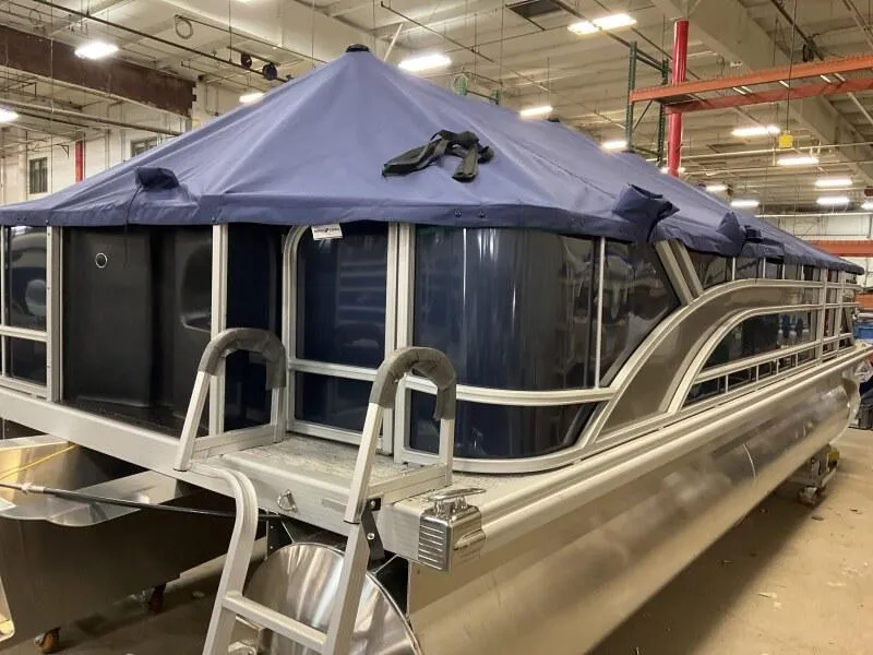 Slide: The Image of 2025 Bennington 22 SF pontoon boat with cover in warehouse setting. - 26
