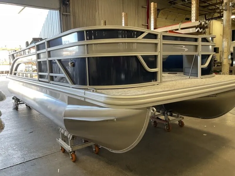 Slide: The Image of 2025 Bennington 22 SF Family Pontoon with 4 fishing seats in stock, displayed indoors. - 27