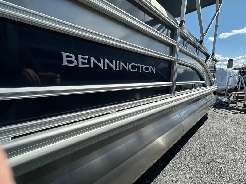 Slide: The Image of 2025 Bennington 22 SF Family Pontoon with 4 fishing seats, docked under clear sky. - 31