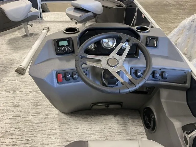 Slide: The Image of 2025 Bennington 22 SF Family Pontoon boat dashboard with steering wheel and controls. - 4