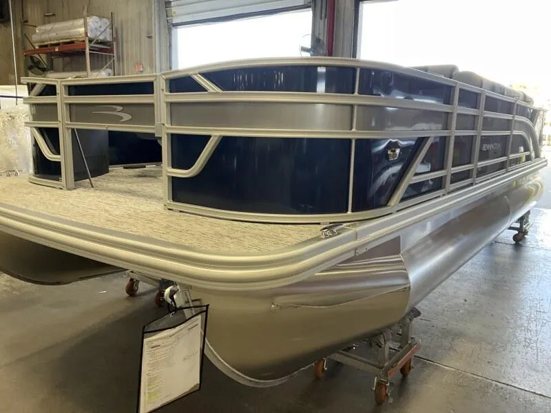 Slide: The Image of 2025 Bennington 22 SF Family Pontoon with four fishing seats in stock, displayed indoors. - 6