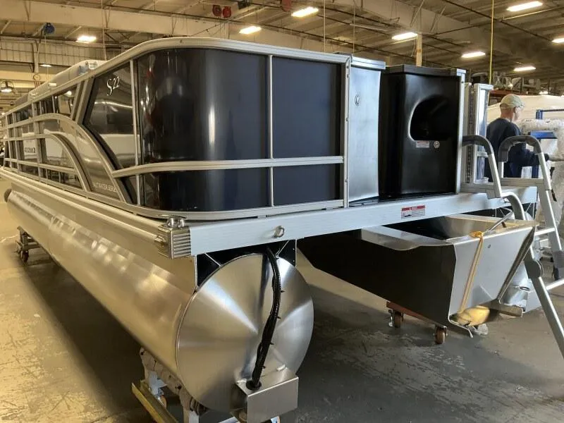 Slide: The Image of 2025 Bennington 22 SF Family Pontoon with 4 fishing seats in a warehouse setting. - 8