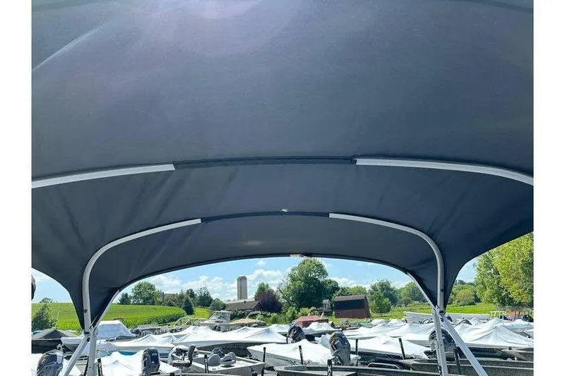 Slide: The Image of 2026 Bennington 20 SS boat canopy with scenic outdoor background. - 22