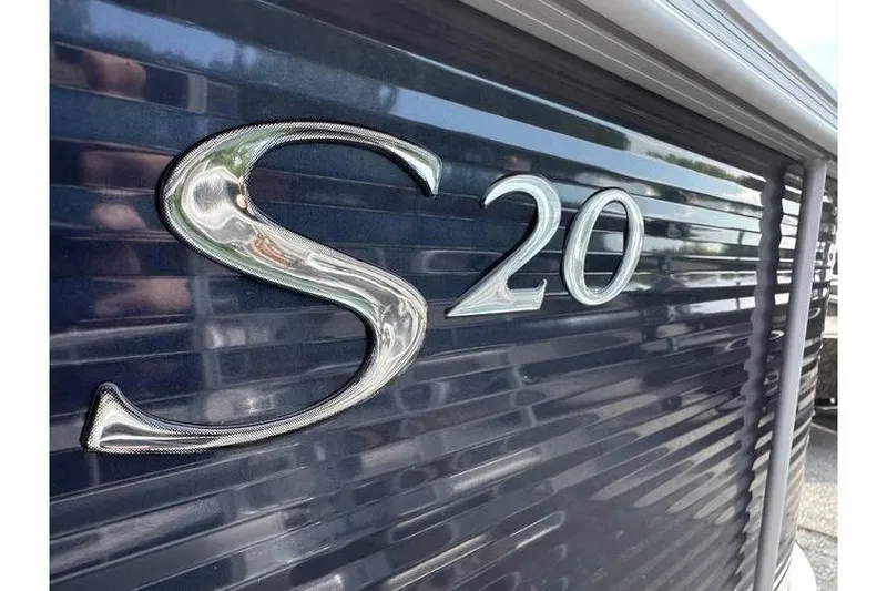 Slide: The Image of Close-up of Bennington 20 SS Family/Fishing boat, model year 2026, with metallic 'S 20' emblem. - 8