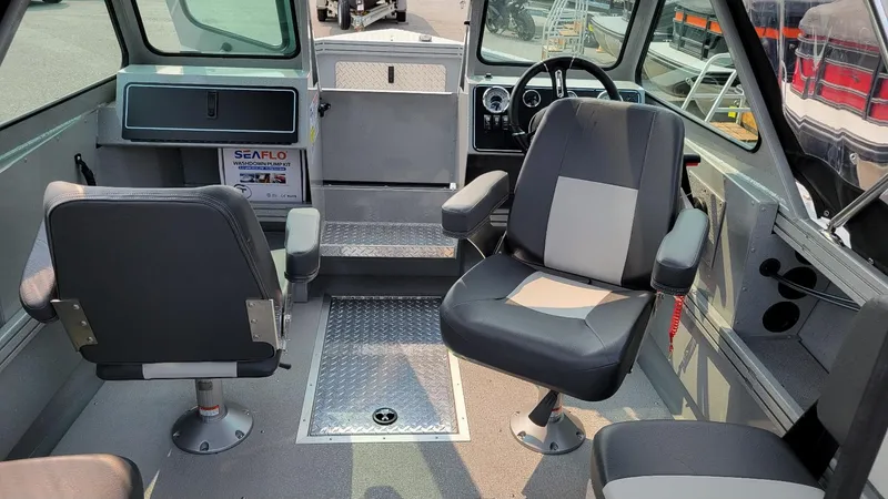 Slide: The Image of 2026 Smoker Craft Phantom 18 X2 boat interior with seating and steering wheel. - 23