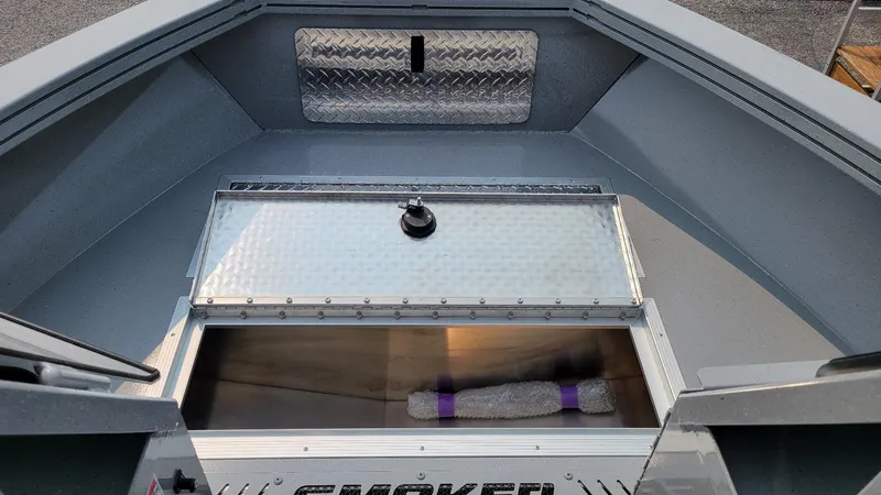 Slide: The Image of 2026 Smoker Craft Phantom 18 X2 boat interior with storage compartment open. - 29
