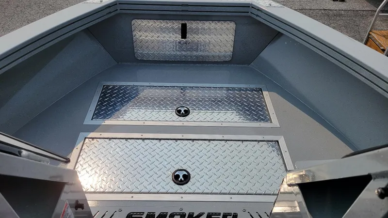 Slide: The Image of 2026 Smoker Craft Phantom 18 X2 boat interior with diamond plate flooring. - 7