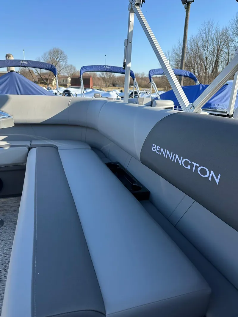 Slide: The Image of 2025 Bennington 188 SS Family Fish Pontoon interior with gray seating and logo. - 41