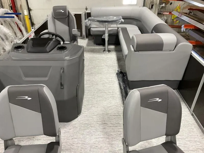 Slide: The Image of 2025 Bennington 188 SS Family Fish Pontoon interior with gray seating and helm. - 6
