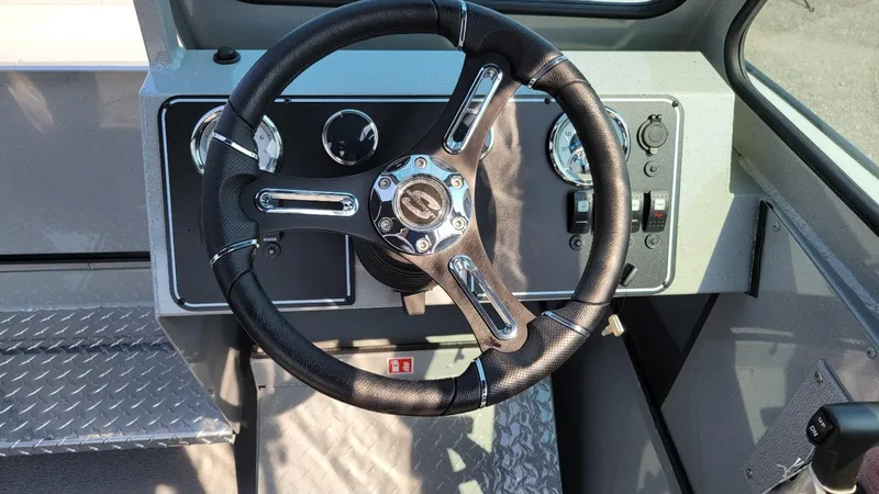 Slide: The Image of 2026 Smoker Craft Pro Sportsman 2072 dual console dashboard with steering wheel and controls. - 18