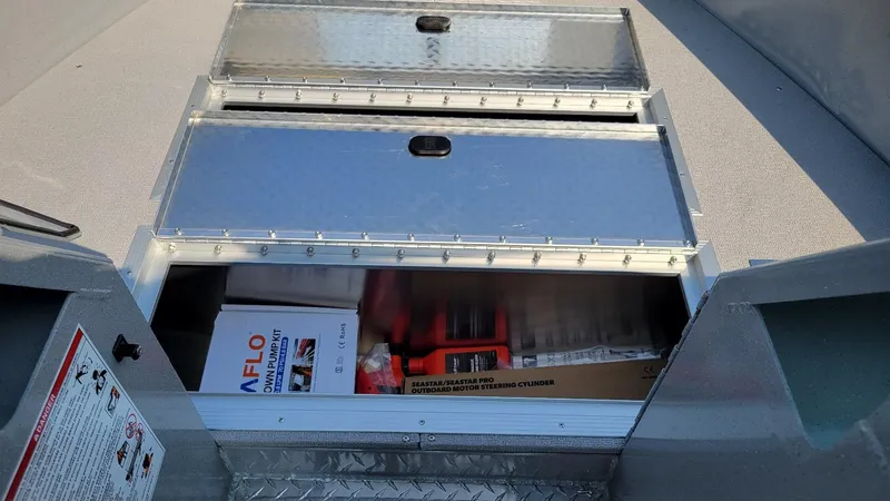 Slide: The Image of Storage compartment of 2026 Smoker Craft Pro Sportsman 2072 boat with equipment inside. - 20