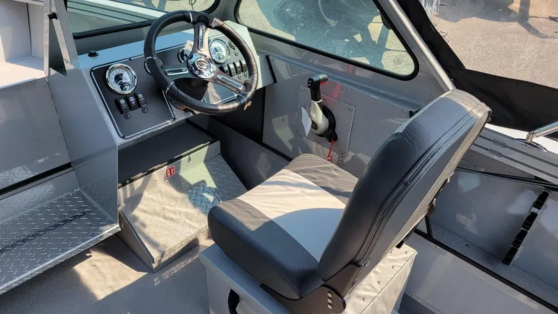 Slide: The Image of 2026 Smoker Craft Pro Sportsman 2072 dual console interior with steering wheel and seat. - 6