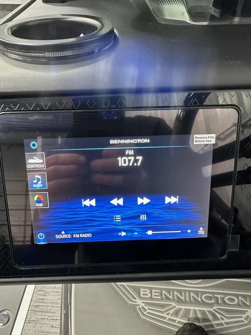 Slide: The Image of Touchscreen display on 2025 Bennington 22 MFB Tritoon, showing FM radio controls. - 13