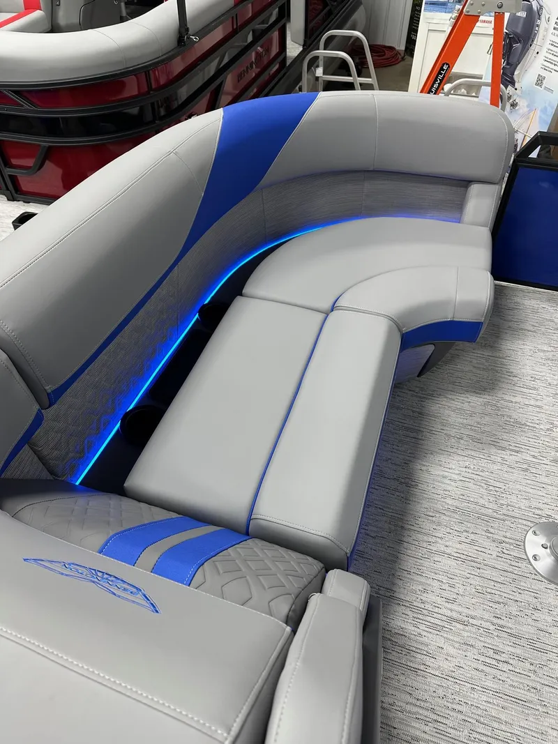 Slide: The Image of 2025 Bennington 22 MFB Tritoon interior with gray and blue seating, featuring LED lighting. - 15