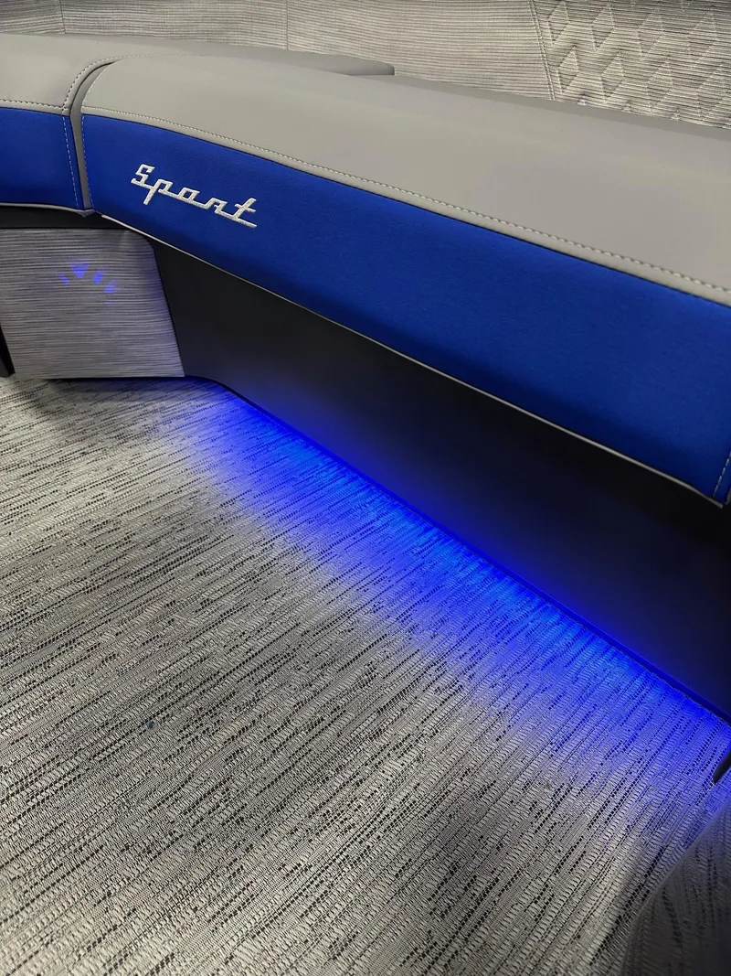 Slide: The Image of 2025 Bennington 22 MFB Tritoon interior with blue LED lighting and "Sport" branding. - 16