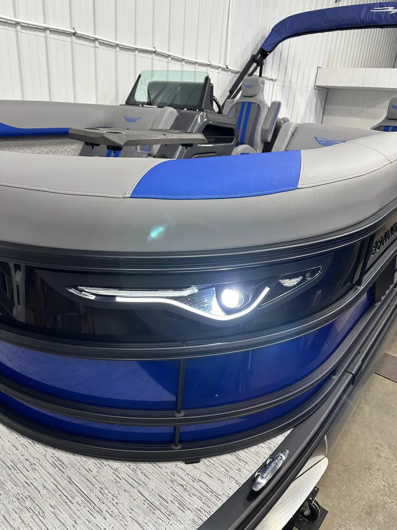 Slide: The Image of 2025 Bennington 22 MFB Tritoon with sleek design and modern seating in showroom. - 18