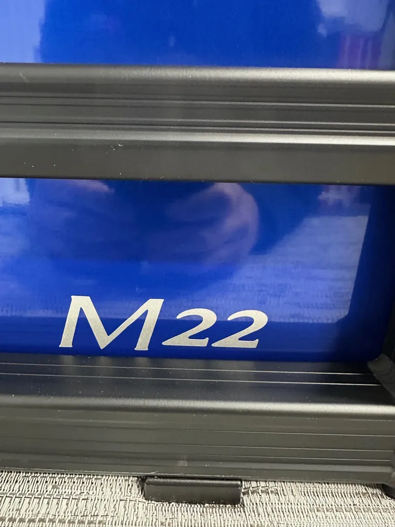 Slide: The Image of 2025 Bennington 22 MFB M-Series Tritoon with "M22" label, blue and black design. - 19