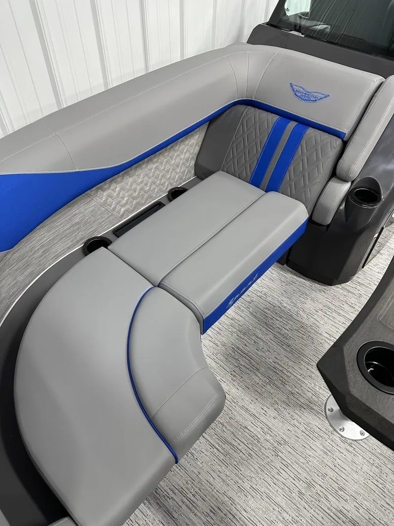 Slide: The Image of 2025 Bennington 22 MFB Tritoon interior with gray and blue seating, cup holders, and modern design. - 29