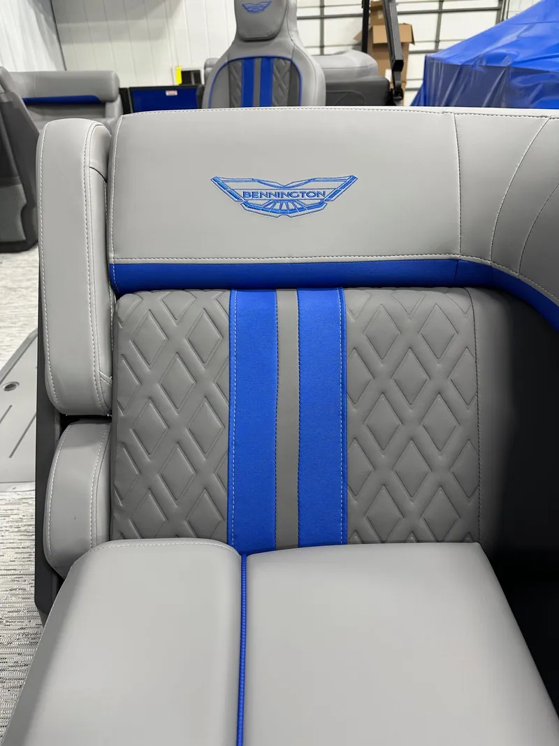 Slide: The Image of 2025 Bennington 22 MFB Tritoon interior with gray and blue diamond-stitched seating. - 30