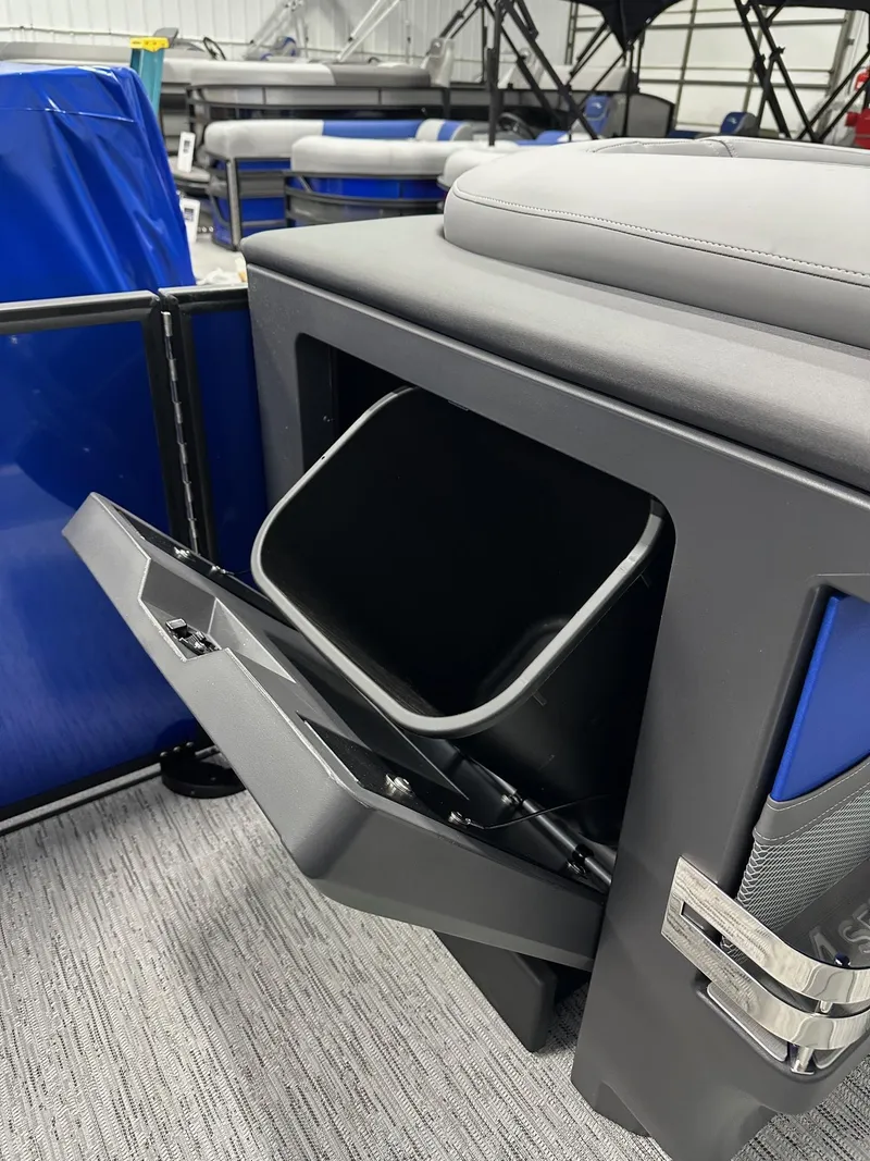 Slide: The Image of 2025 Bennington 22 MFB Tritoon storage compartment with open door, showcasing interior space. - 34