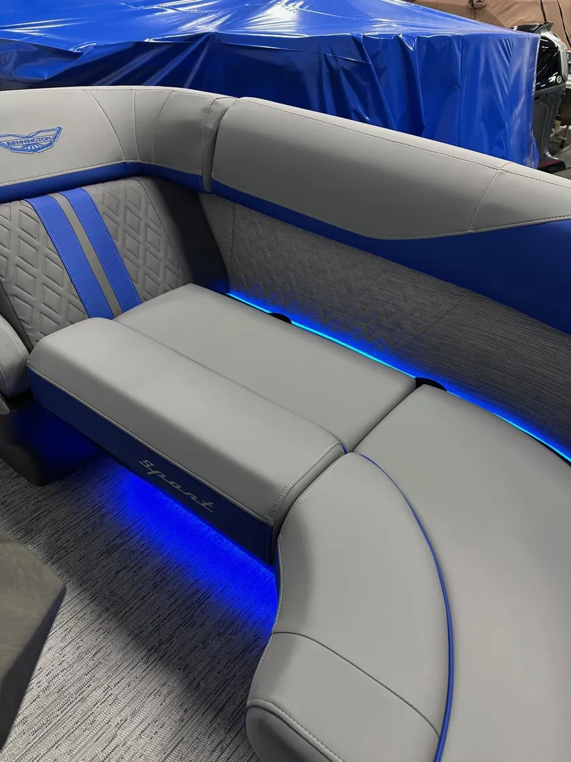 Slide: The Image of 2025 Bennington 22 MFB Tritoon interior with blue LED lighting and gray upholstery. - 42