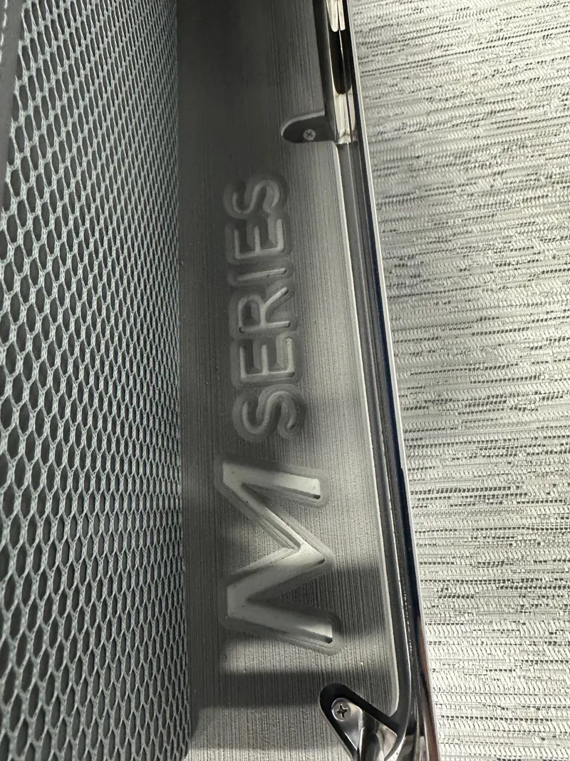 Slide: The Image of Close-up of 2025 Bennington M-Series Tritoon boat detail with textured surface. - 7
