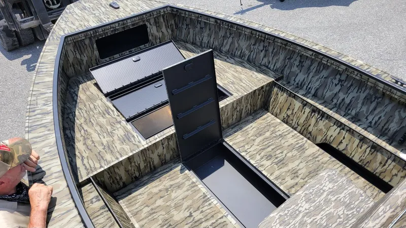 Slide: The Image of 2026 Smoker Craft Pro Sportsman 1872 CC boat interior with camouflage design and storage compartments. - 10